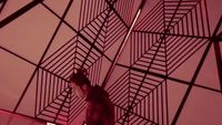 a cat sitting on top of a metal structure