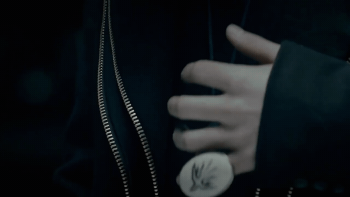 a close up of a person's hand holding a button