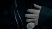 a close up of a person's hand holding a button