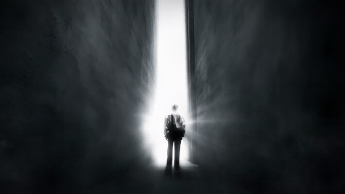 a man standing in the middle of a dark hallway