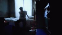 a blurry image of a person standing in front of a window
