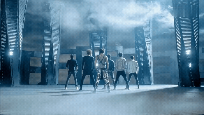 a group of people standing in front of tall buildings