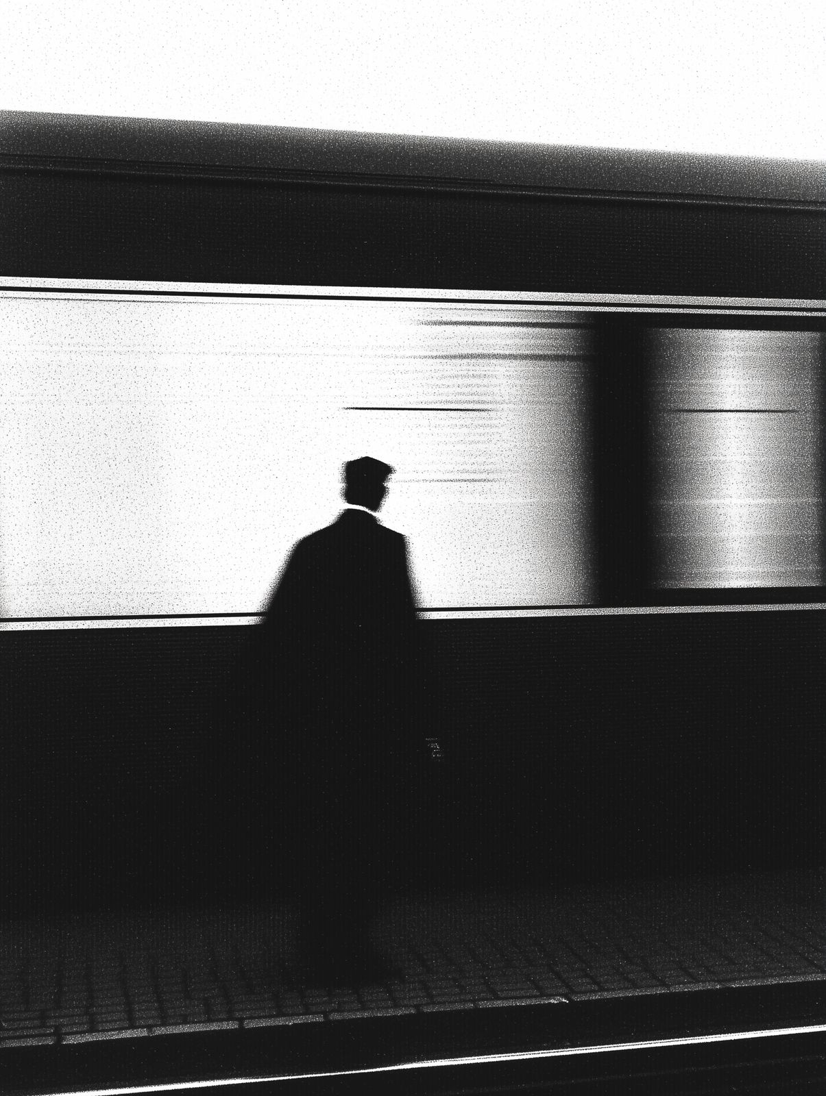 a black and white photo of a man in a hat