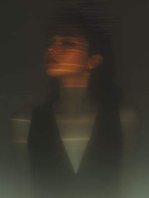 a blurry photo of a woman's face and neck