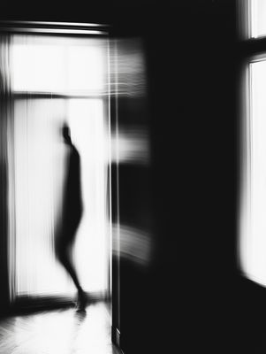 a blurry photo of a person walking into a room