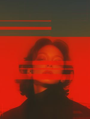 a woman's face is seen through a red and black photo