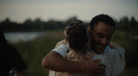 a man holding a little girl in his arms