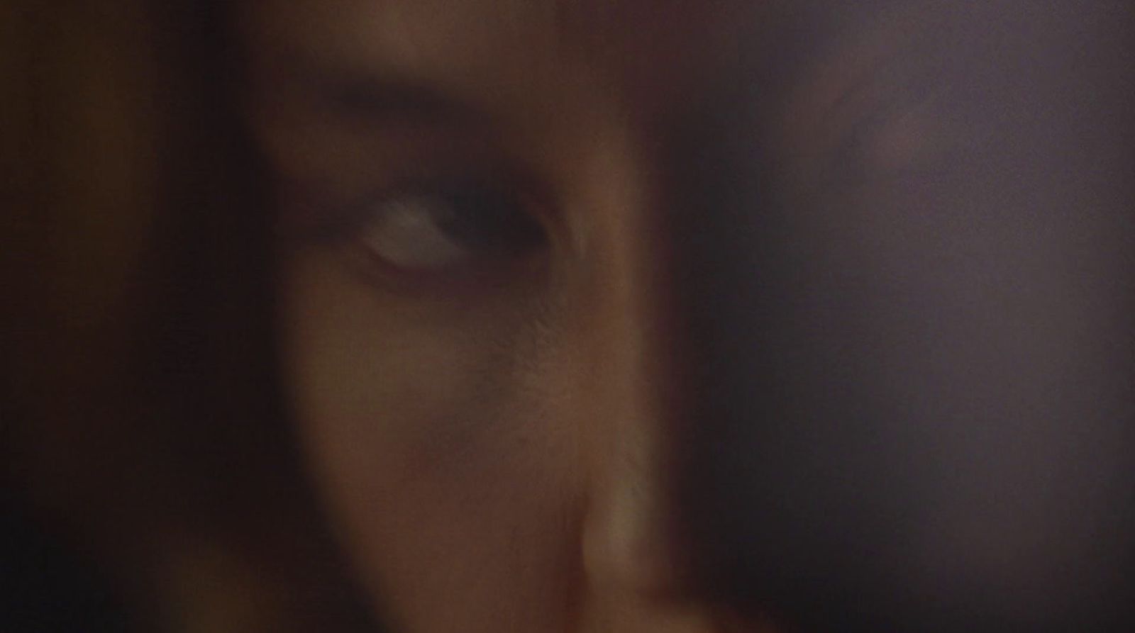 a blurry photo of a person's face with a cell phone