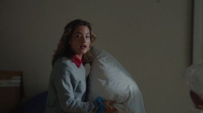 a woman holding a pillow in a bedroom