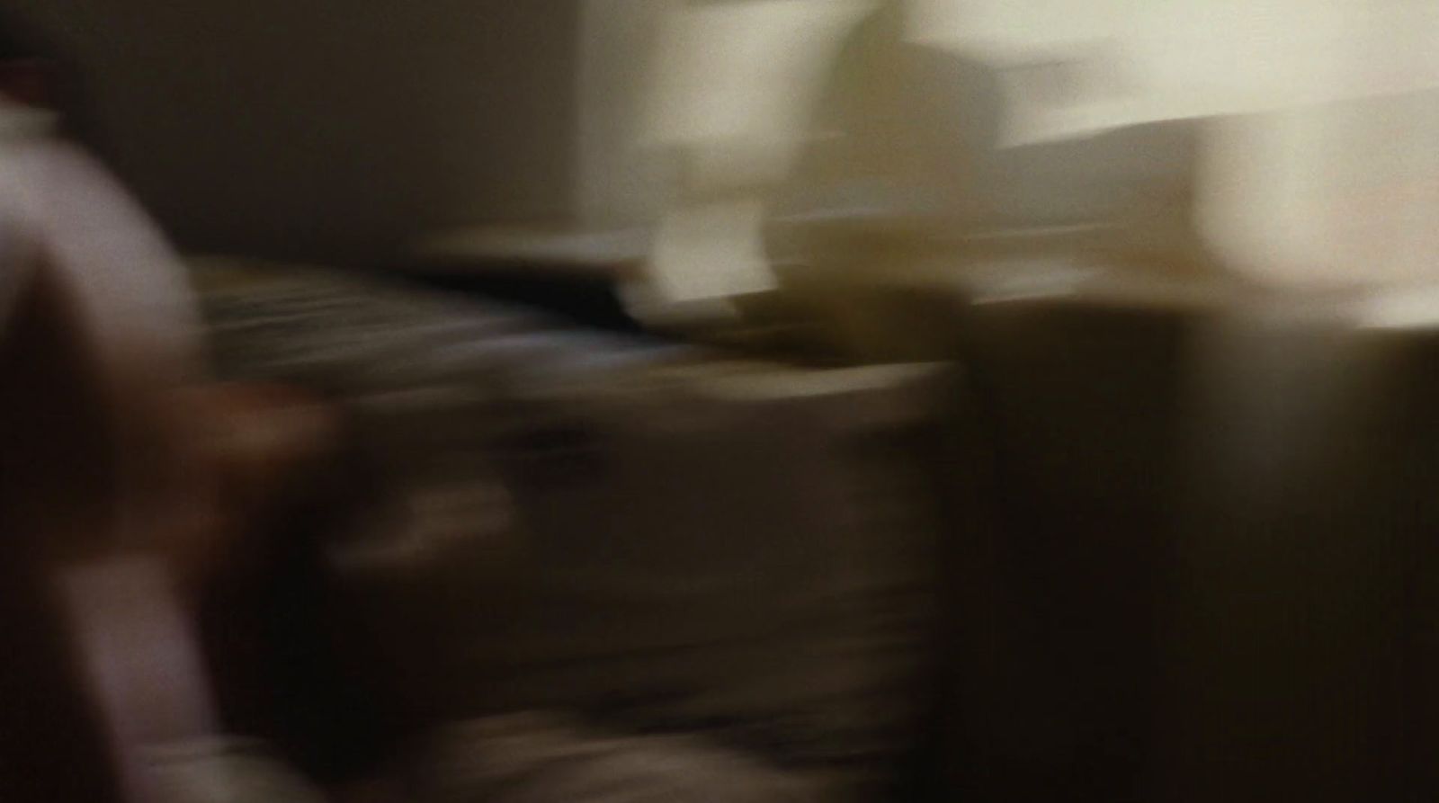 a blurry photo of a person sitting on a couch