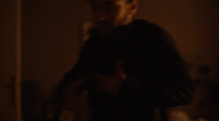 a man in a dark room holding a camera