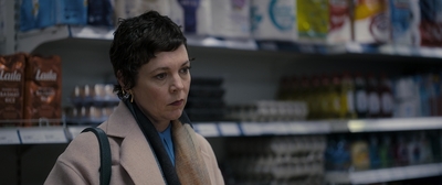 a woman standing in front of a store shelf