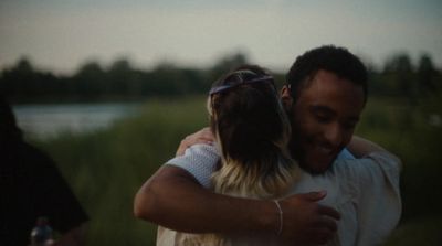 a man hugging a woman in a field