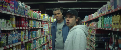 a couple of men standing in a store aisle