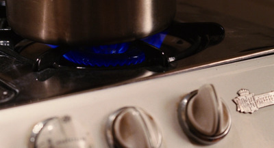 a stove top with a pot on top of it