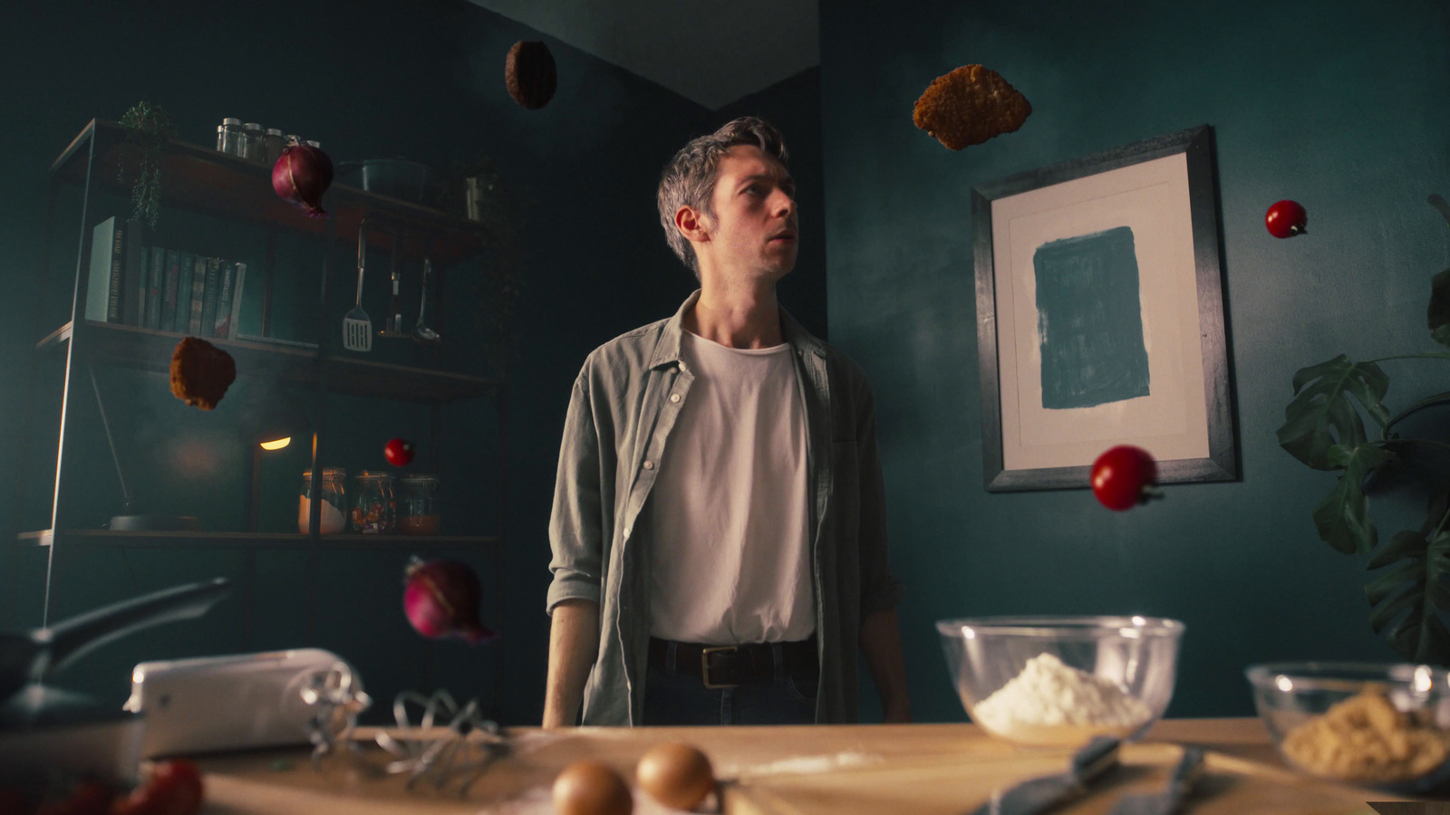 a man standing in front of a kitchen counter