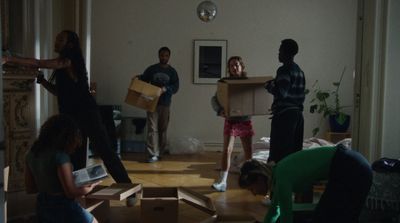 a group of people unpacking boxes in a living room