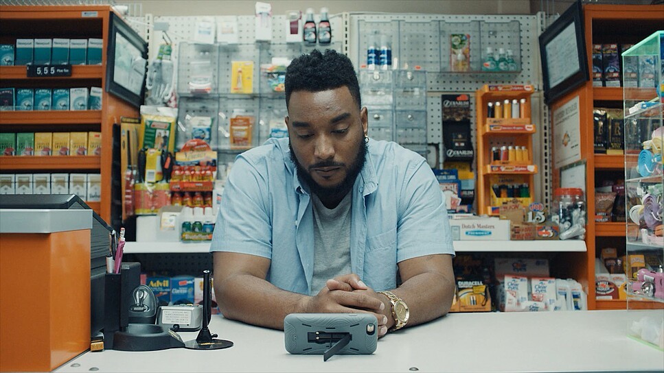 a man sitting at a counter in a store