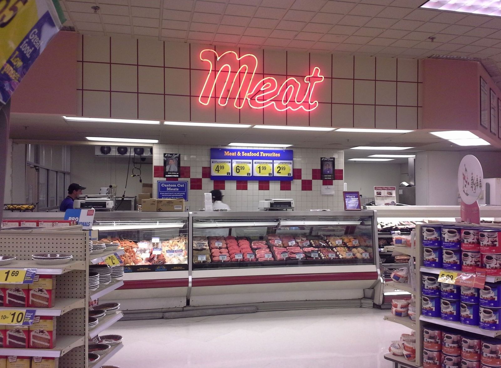 a meat shop with a neon sign above it