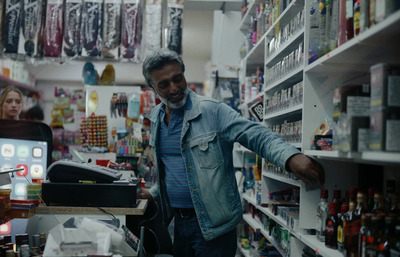 a man in a store looking at items on shelves