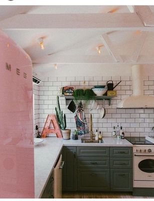 a kitchen with a pink refrigerator freezer next to a stove top oven