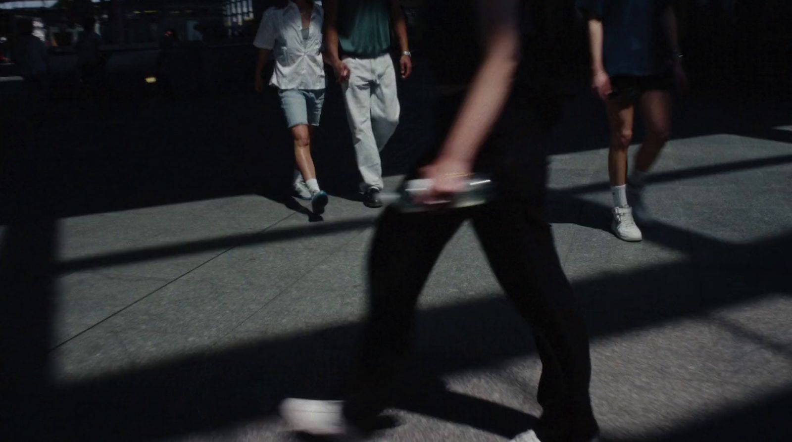 a group of people walking down a street next to each other