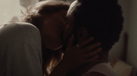 a man and a woman kissing each other