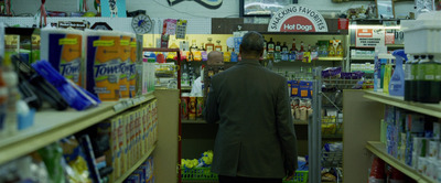 a man walking down a store aisle in a store