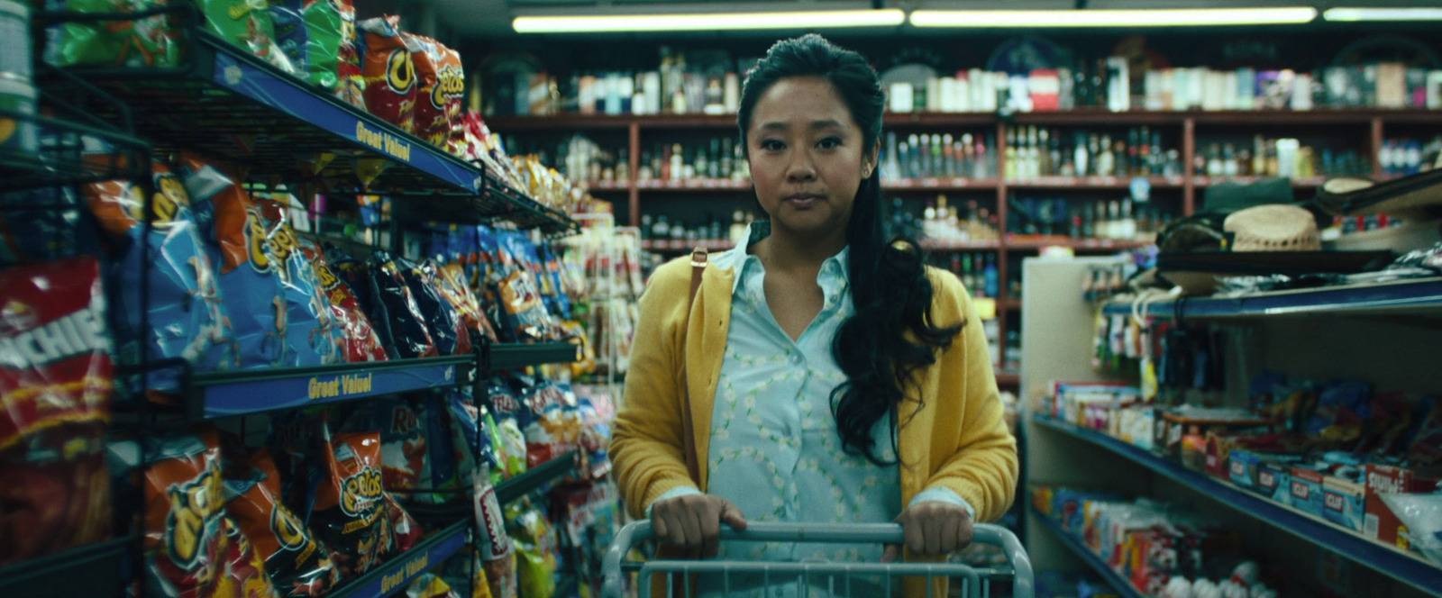 a woman pushing a shopping cart through a store