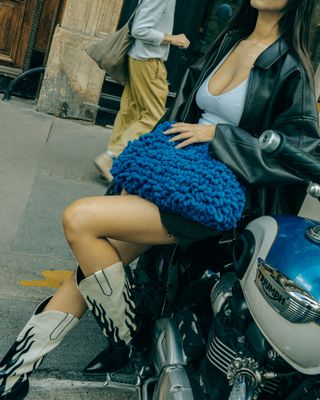 a woman sitting on top of a motorcycle