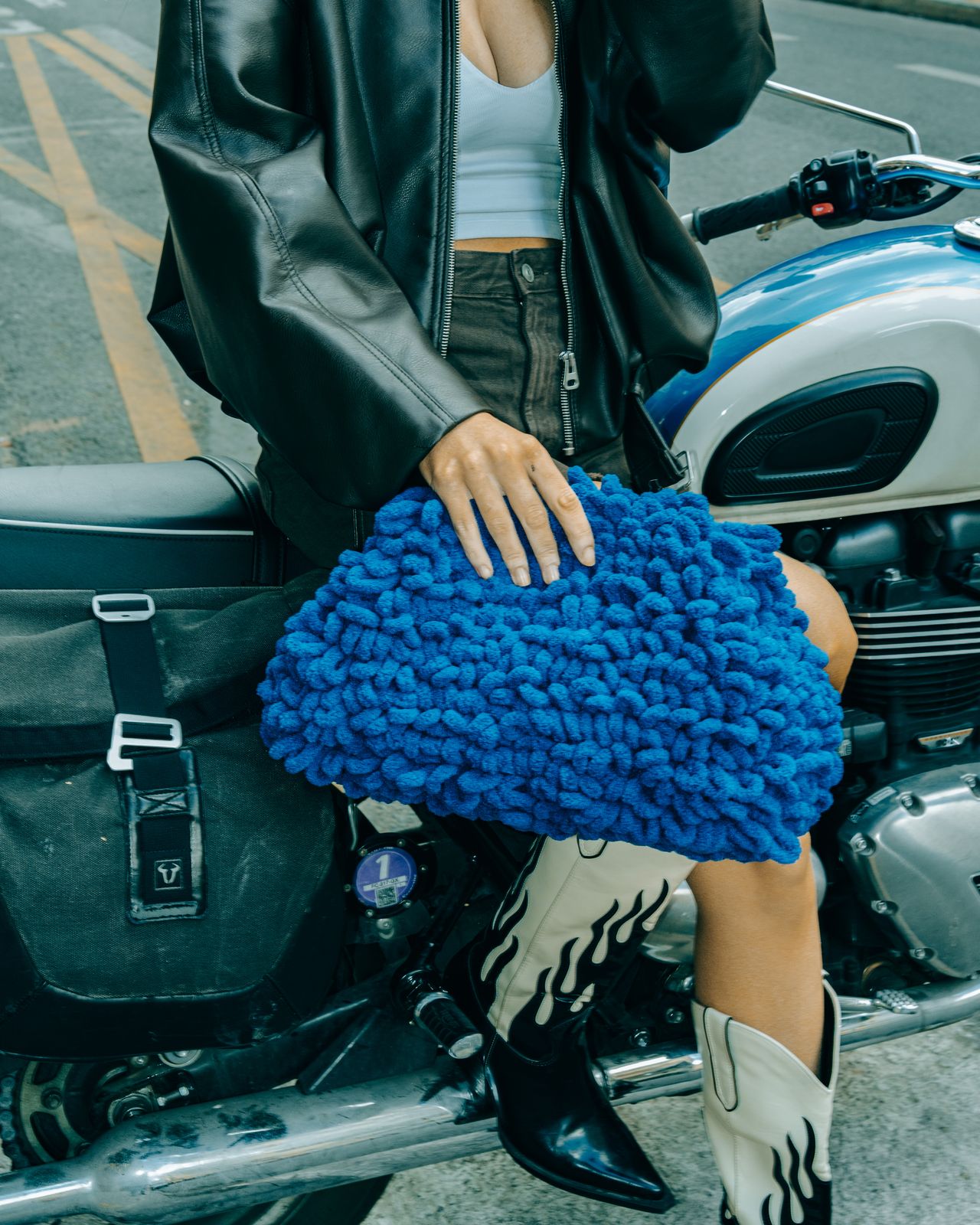 a woman sitting on the back of a motorcycle