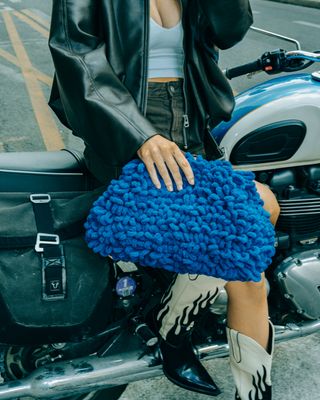 a woman sitting on the back of a motorcycle