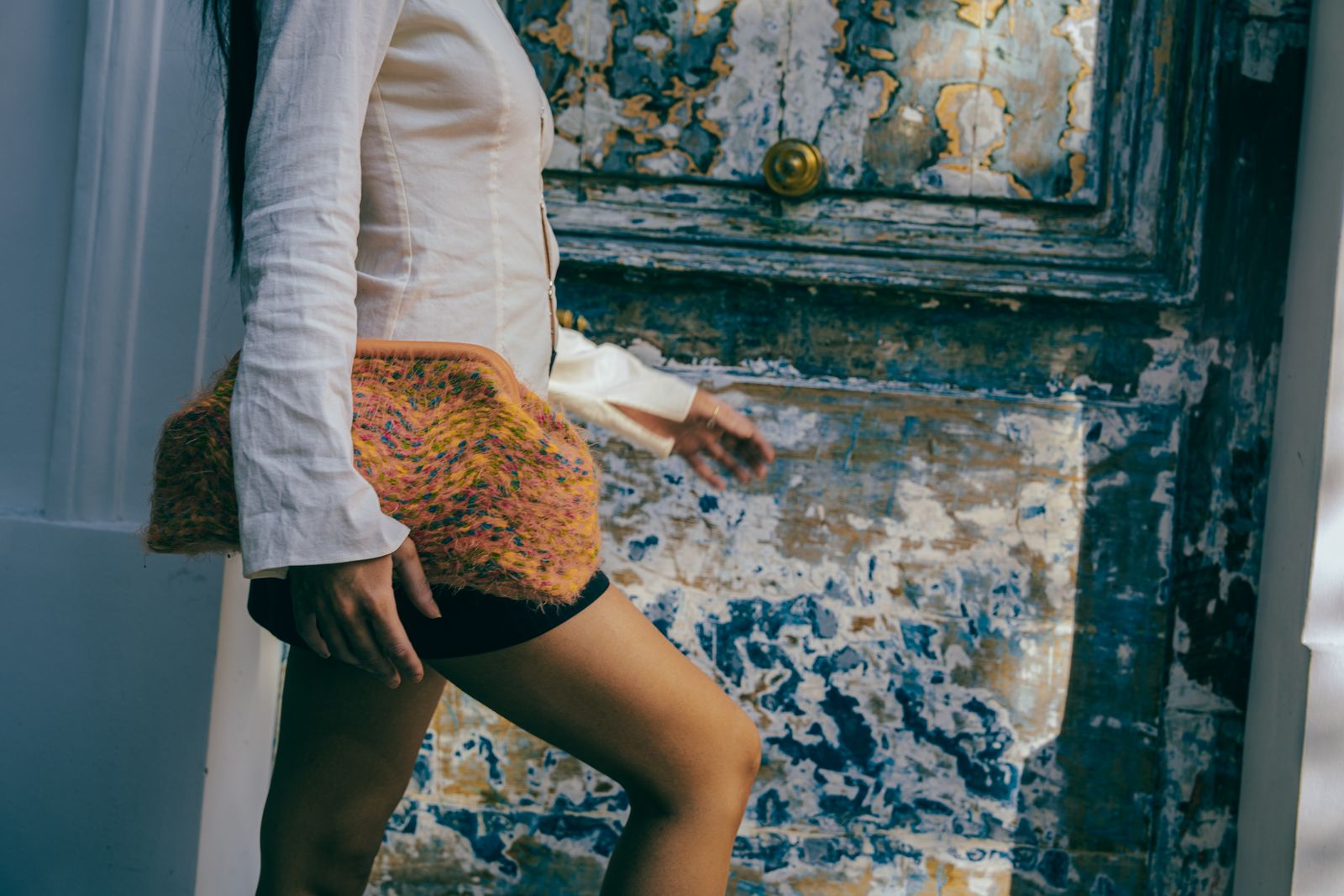 a woman is standing in front of a door