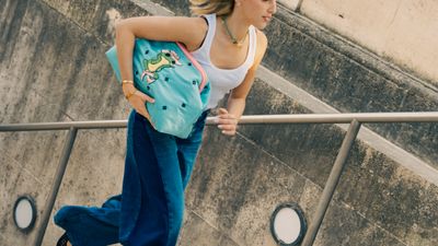 a woman with a back pack walking up a set of stairs