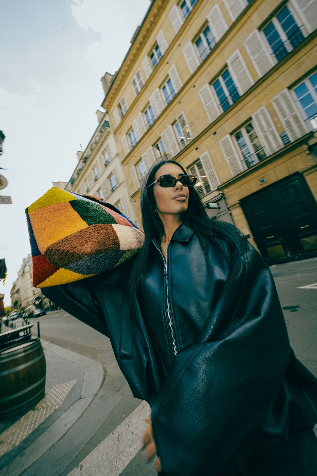 a woman wearing sunglasses and a black jacket