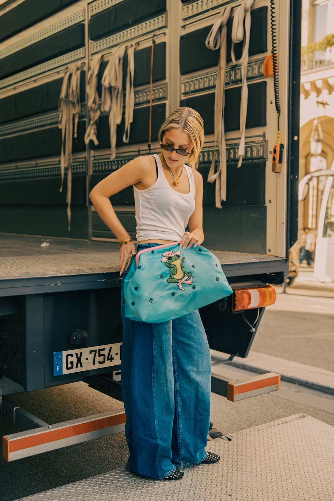 a woman standing in front of a large truck