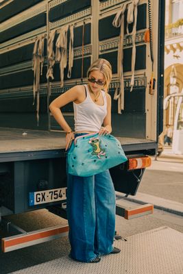 a woman standing in front of a large truck