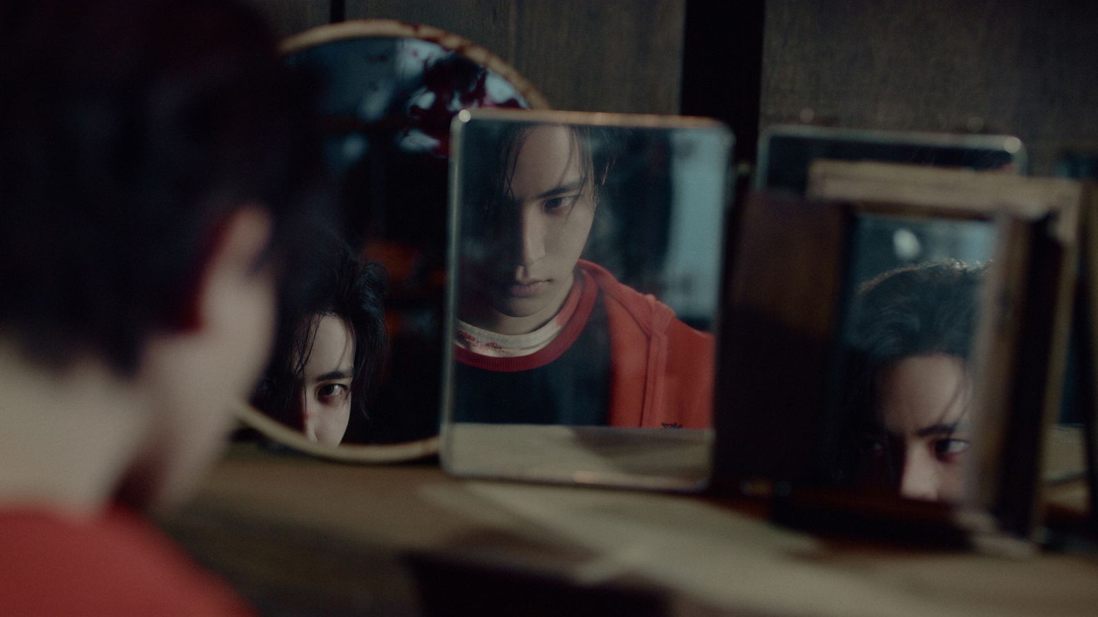 a man looking at his reflection in a mirror