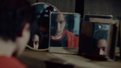 a man looking at his reflection in a mirror