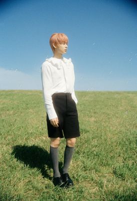 a person standing in a field with a frisbee