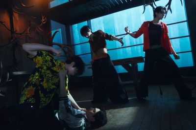 a group of people standing around each other in a room