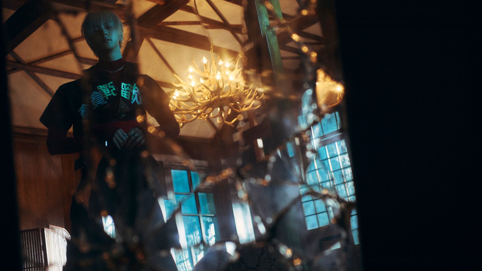 a man standing in front of a chandelier
