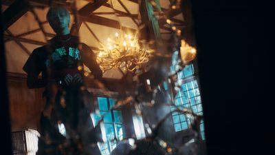 a man standing in front of a chandelier