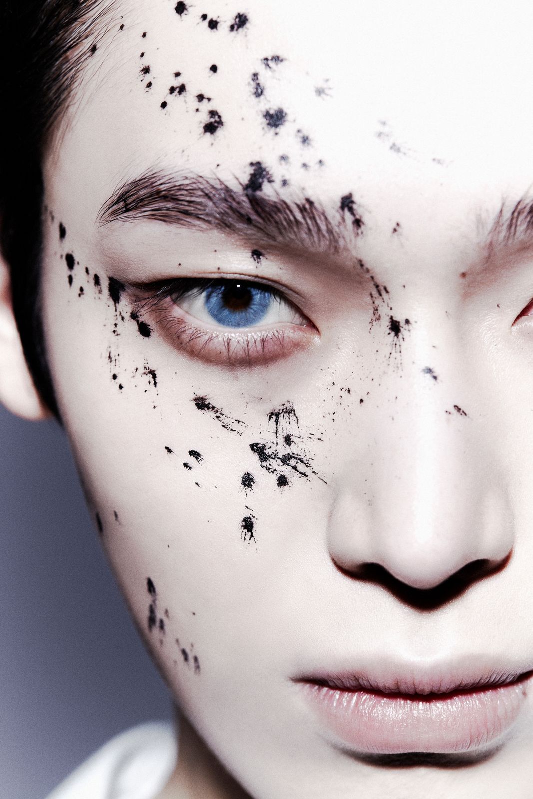 a woman with black spots on her face