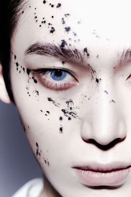 a woman with black spots on her face
