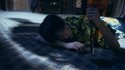 a person laying on the ground with a knife