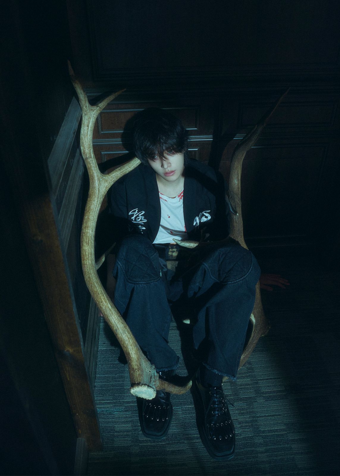 a person sitting in a chair with a fake tree branch