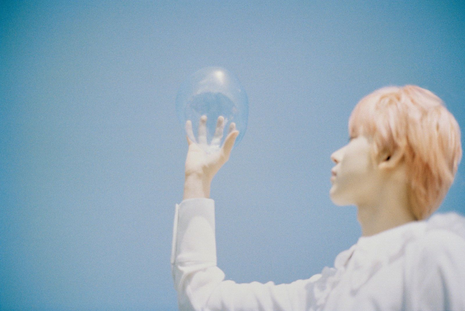 a woman holding a glass ball in her hand