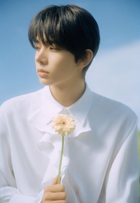 a man in a white shirt holding a flower