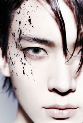 a close up of a person with black spots on his face